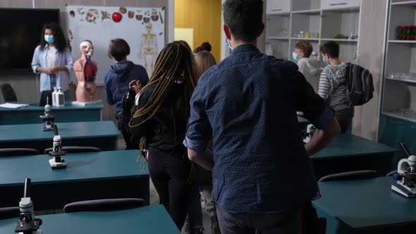 Masked Diverse Pupils Getting Up at End of Lesson alt