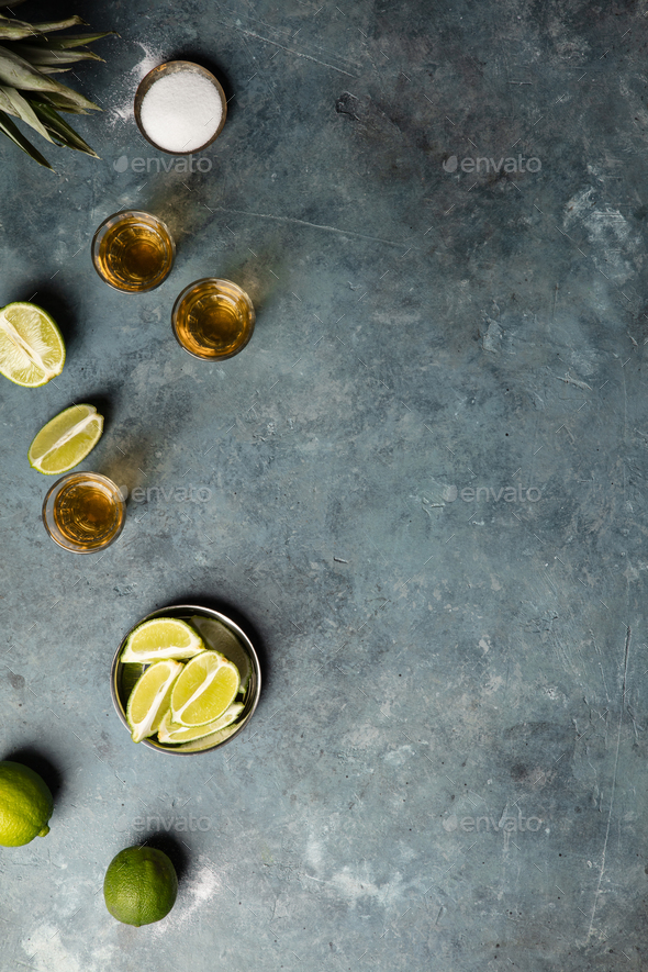 Gold tequila with lime and salt, flat lay