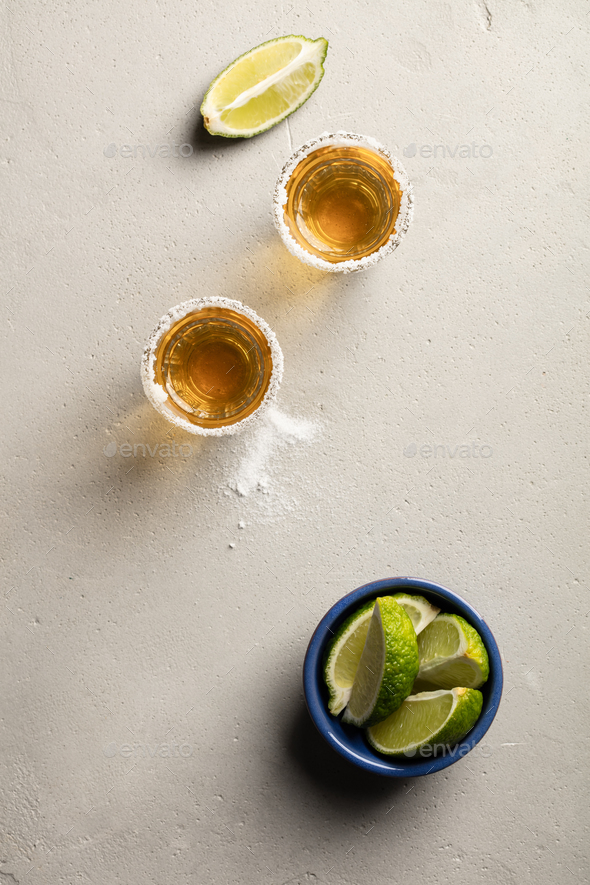 Gold tequila with lime and salt, flat lay