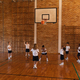 Basketball coach teaching to schoolkids at basketball court in school - $5.00 Basketball coach teaching to schoolkids at basketball court in school