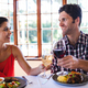 Smiling couple toasting wine glass at the table in restaurant - $5.00 Smiling couple toasting wine glass at the table in restaurant