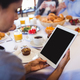 Close-up of businesswoman using digital tablet in restaurant - $5.00 Close-up of businesswoman using digital tablet in restaurant