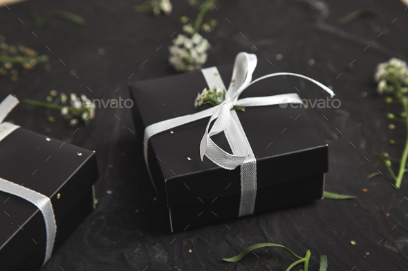 Gift boxes in Black and White color with flowers. Wrapping modern