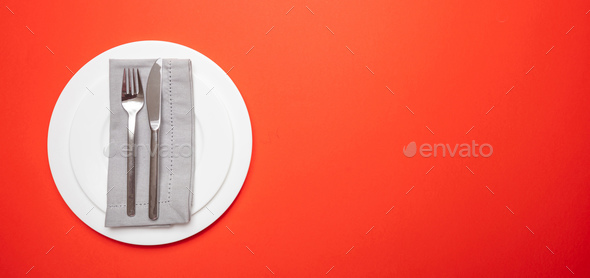 Set of empty white plates and cutlery on red, orange color background, banner - Stock Photo - Images