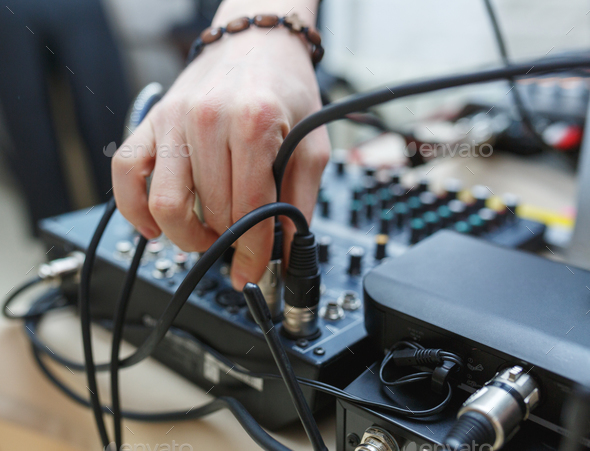 DJ connects the sound equipment for the event or party. - Stock Photo - Images
