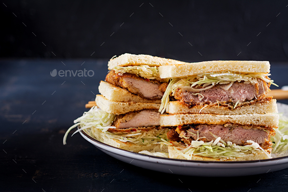 Katsu Sando - food trend japanese sandwich with breaded pork chop, cabbage and tonkatsu sauce.