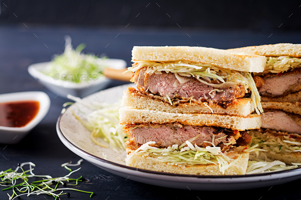 Katsu Sando - food trend japanese sandwich with breaded pork chop, cabbage and tonkatsu sauce.