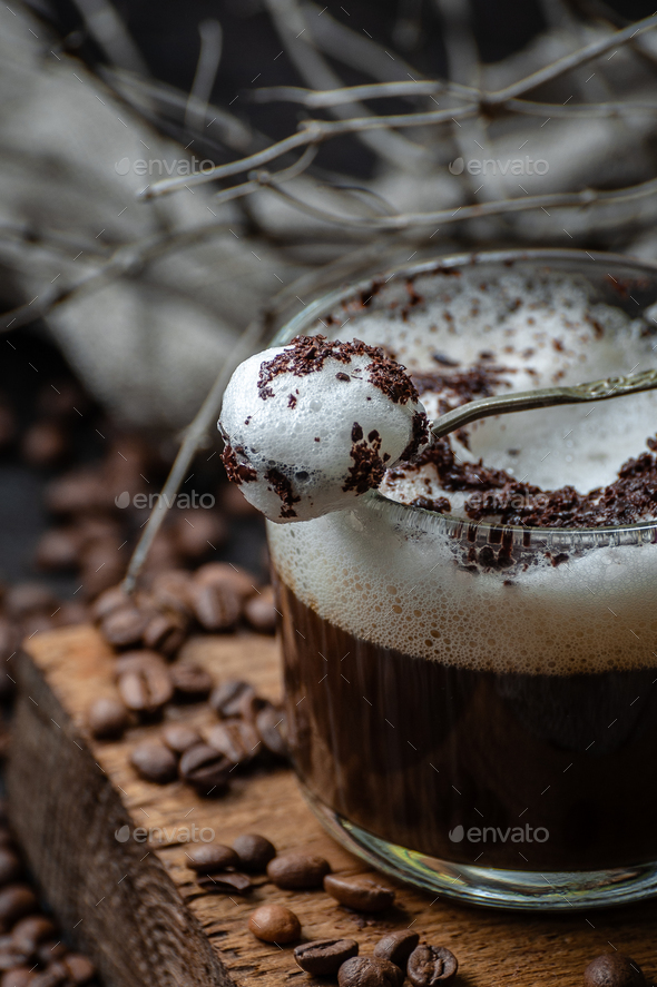 Milk foam with chocolate chips on a cup of cappuccino. - Stock Photo - Images
