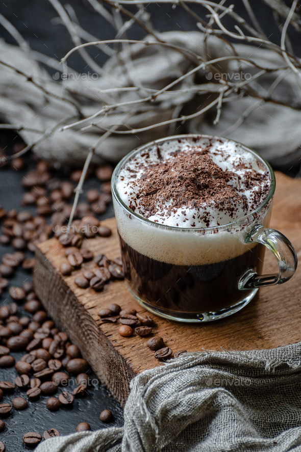 Cappuccino coffee with milk foam and chocolate closeup. Low key - Stock Photo - Images