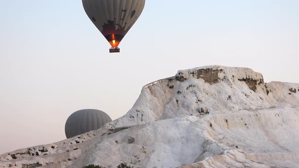 Hot Air Balloons in White Travertines of Pamukkale, a Touristic Natural World Heritage Site alt
