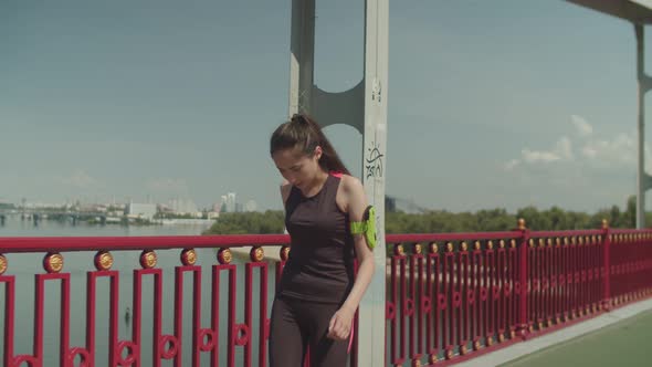 Tired After Running Asian Woman Walking on Bridge alt