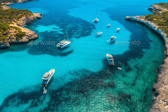 Boats and luxury yachts in transparent sea at sunny day. Aerial - Stock Photo - Images