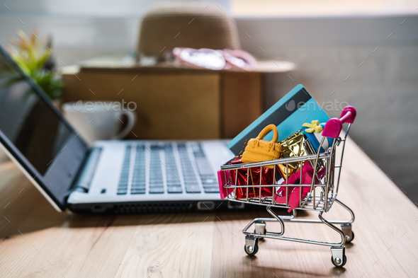 Shopping cart with credit card and woman accessories with laptop, Online shopping concept - Stock Photo - Images