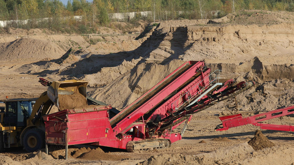 The Heavy Tractor Works in a Sand Quarry