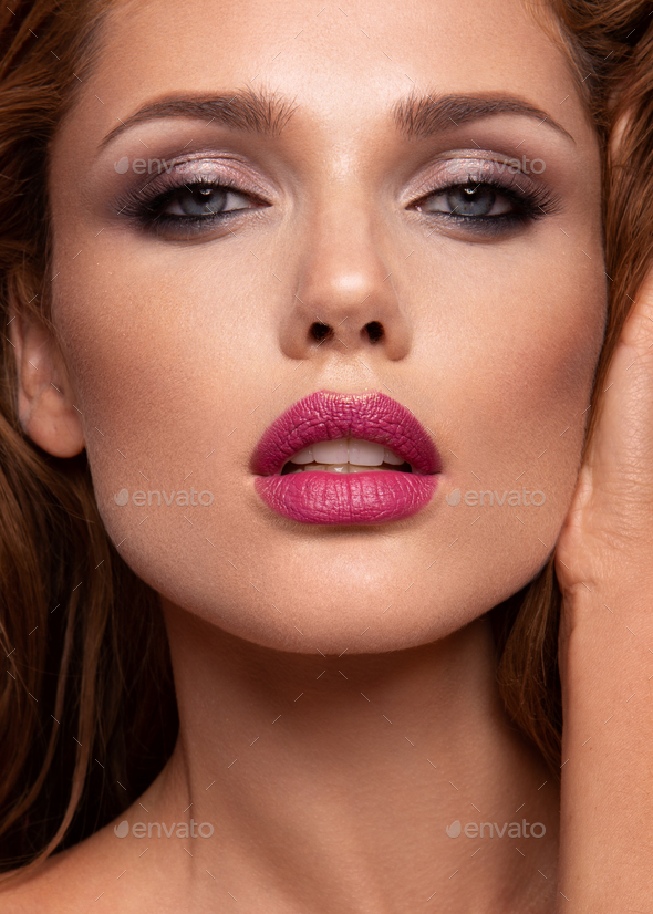 Make up. Glamour portrait of beautiful woman model with fresh makeup and romantic wavy hairstyle - Stock Photo - Images