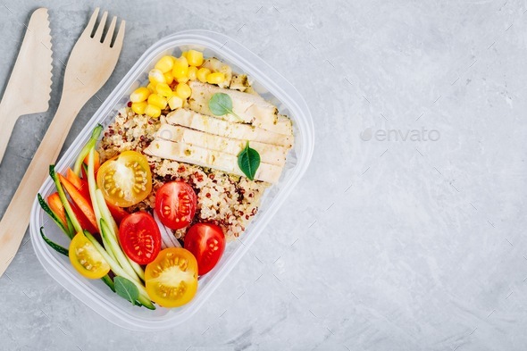 Meal prep containers with quinoa, fresh vegetables and chicken