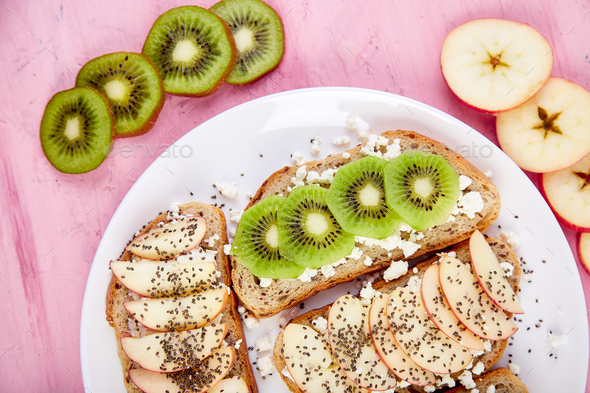 Healthy breakfast toasts with kiwi, apple, cottage cheese and chia seeds - Stock Photo - Images