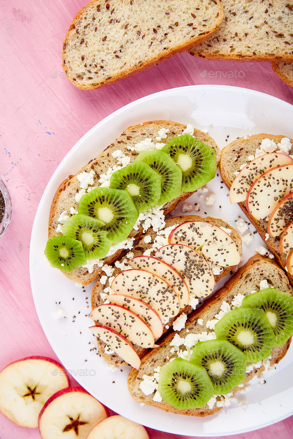 Healthy breakfast toasts with kiwi, apple, cottage cheese and chia seeds - Stock Photo - Images