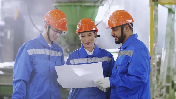 Smiling engineer sharing experience with foreign colleagues at manufactory