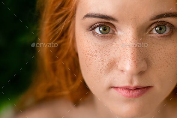 Beautiful young freckled green-eyed lady with red hair Stock Photo by  Prostock-studio
