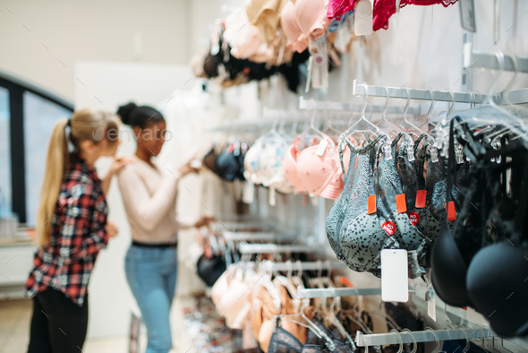 Female Are Choosing Panties In Underwear Shop. Stock Photo