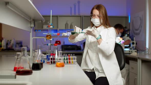 Young Scientist Mixing Colored Liquids