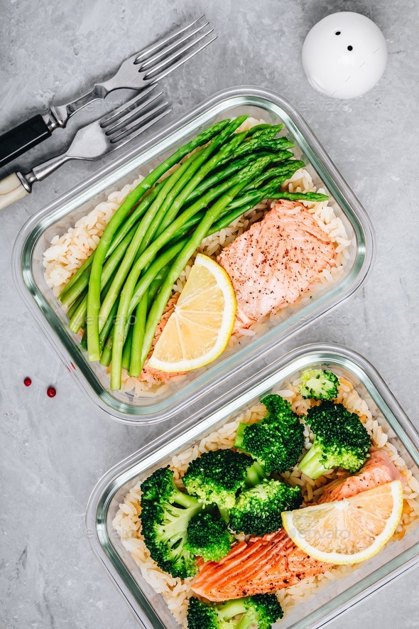 Meal prep lunch box containers with baked salmon fish, rice, green