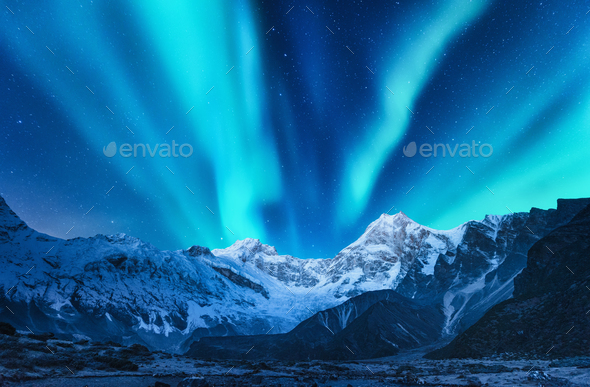 Aurora borealis above snow covered mountain range in europe - Stock Photo - Images