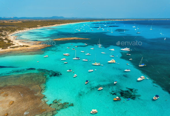 Boats and luxury yachts in transparent sea at sunset in summer - Stock Photo - Images