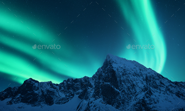 Aurora borealis above snow covered mountain range in europe - Stock Photo - Images