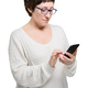 Brunette woman in glasses makes purchases in the online store with phone and credit card - PhotoDune Item for Sale
