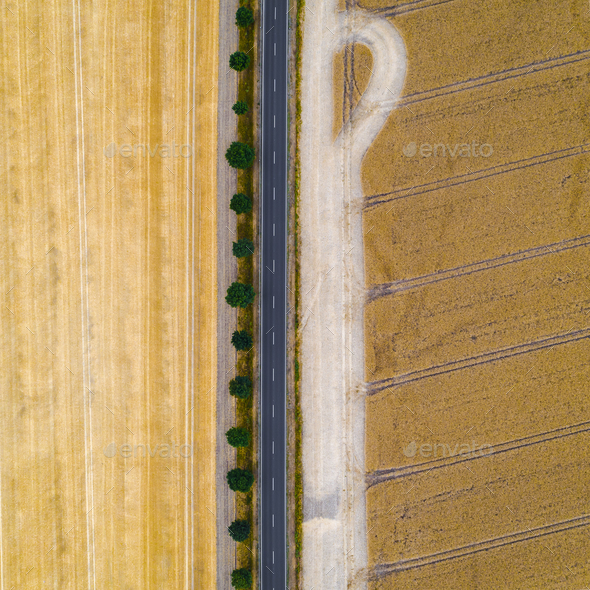 Aerial view of a country road between agricultural fields in Europe - Stock Photo - Images