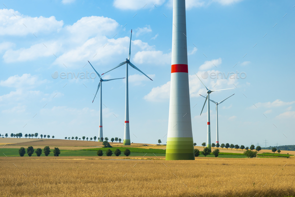 Wind turbines and agricultural fields on a summer day - Stock Photo - Images