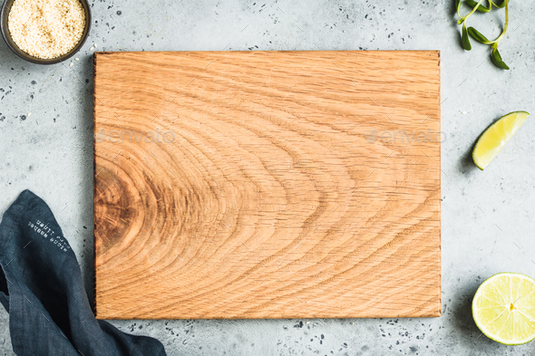 Empty wooden cutting board on a kitchen table. Top view, copy