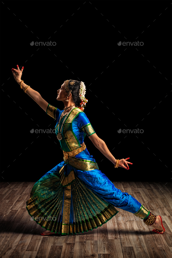 a beautiful Sundanese dancer poses and dances in a glamorous dress and  scarf in front of the stage light 27123148 Stock Photo at Vecteezy