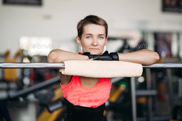 Woman With Short Hair In Pink Wear Resting In Gym After Workout