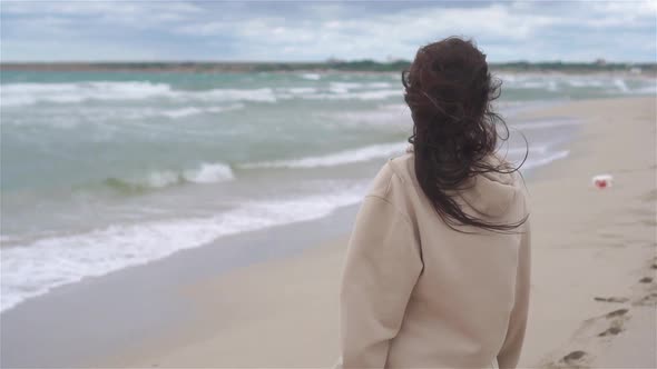 Young Woman in White on the Beach alt