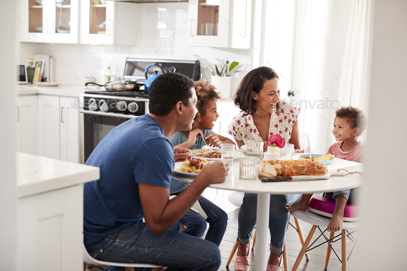 Mixed Race Friends Relaxing in Kitchen Bonding Together Drinking