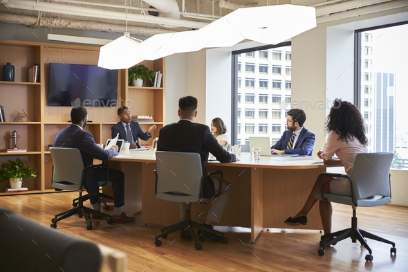 Group Of Business Professionals Meeting Around Table In Modern Office Stock  Photo by monkeybusiness