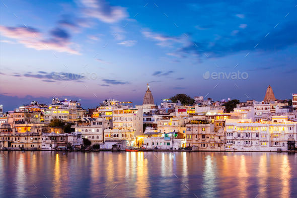 Evening view of illuminated houses on lake Pichola in Udaipur - Stock Photo - Images