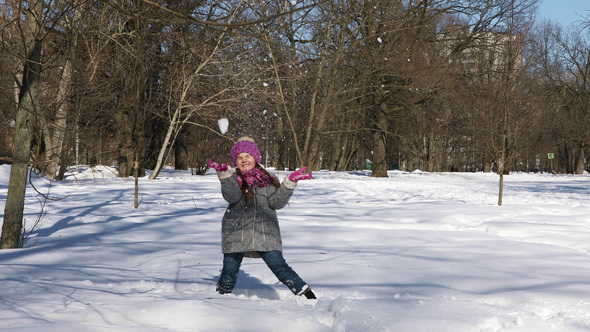 Little Caucasian Girl Having Fun in Winter City Park
