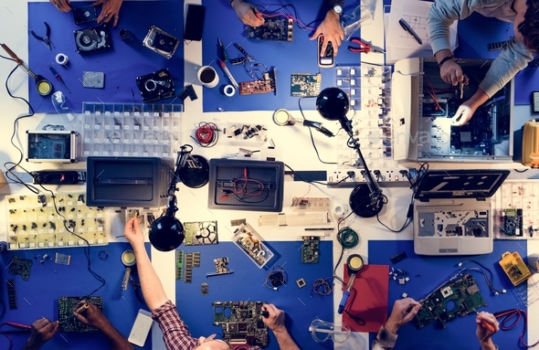 Aerial view of electronics technicians team working on computer