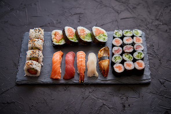 Sushi Set. Different kinds of sushi rolls on wooden serving board Stock  Photo by Daniel_Dash