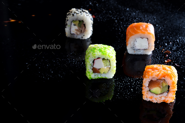 Colorful sushi sets with lots of sushi, roll . Stylish sushi sets on a black background with water - Stock Photo - Images