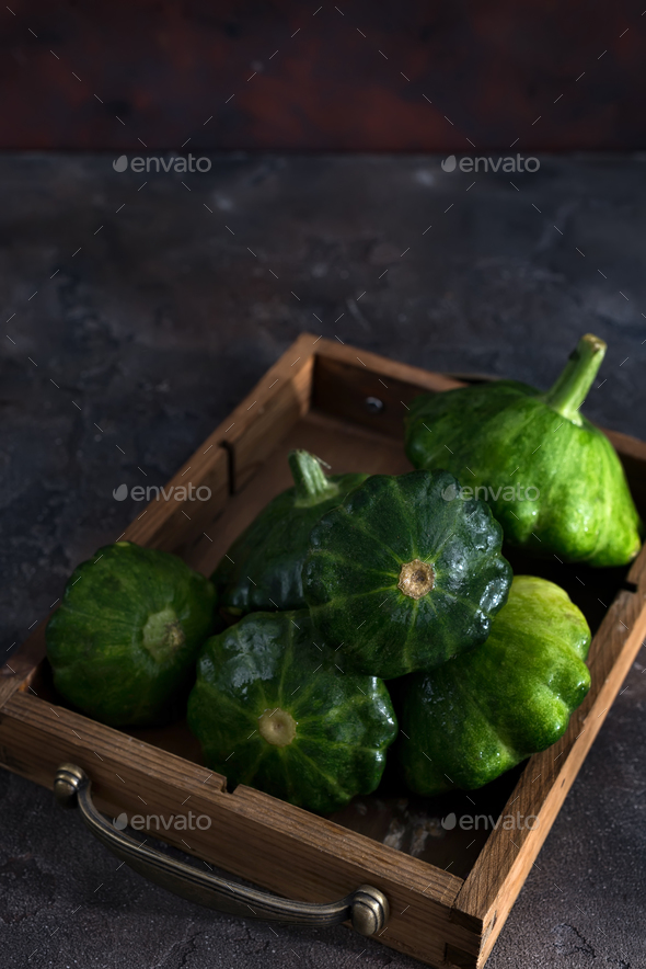 small size patty pan patisson squash in wooden box on dark wooden background with copy space