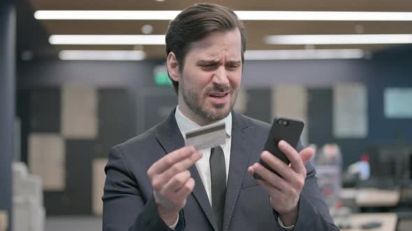 Portrait of Businessman Unable to Make Online Payment on Smartphone alt