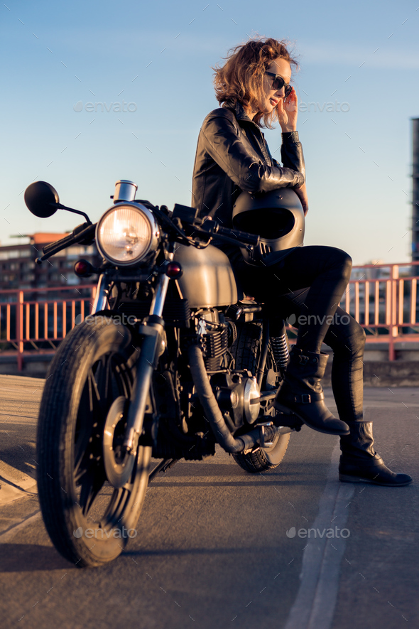 Biker girl on caferacer motorcycle.