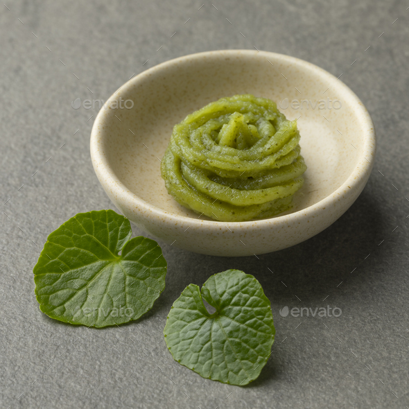 Dish with traditional Japanese horseradish paste and wasabi leav Stock
