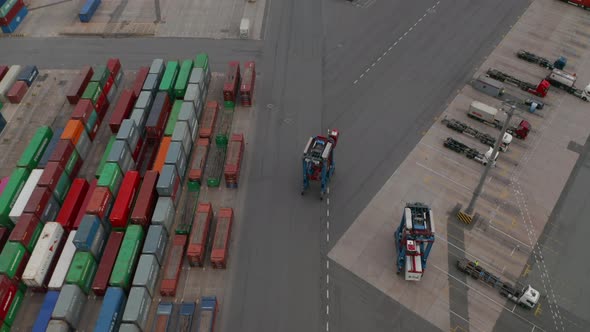 Aerial Overhead View Following a Forklift Operating in Cargo Container Terminal in Hamburg Germany alt
