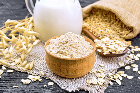 Flour oat in bowl on board - Stock Photo - Images